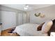 Bright bedroom with wood floors, modern ceiling fan, and closet space at 6603 S Juanita St, Tampa, FL 33616
