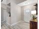 Bright foyer featuring new laminate floors, an accent table, and a modern front door at 6603 S Juanita St, Tampa, FL 33616