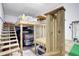 Garage with a built-in wooden structure and stairs, offering ample storage and workspace solutions at 6603 S Juanita St, Tampa, FL 33616