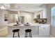 Bright kitchen with stainless steel appliances, white cabinets, and a marble countertop island at 6603 S Juanita St, Tampa, FL 33616