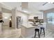Bright kitchen featuring white cabinets, stainless steel appliances, and a two-seater island counter at 6603 S Juanita St, Tampa, FL 33616