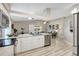 Open-concept kitchen featuring stainless steel appliances and a breakfast bar overlooking the living area at 6603 S Juanita St, Tampa, FL 33616
