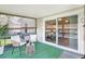 Enclosed lanai with turf, slider, and comfortable seating at 6603 S Juanita St, Tampa, FL 33616