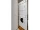 Laundry area with stacked washer and dryer tucked behind a door at 6603 S Juanita St, Tampa, FL 33616