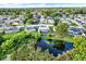 Stunning aerial view of a single Gathering home with a private pool and peaceful pond in the backyard at 7305 Jasmine Blvd, Port Richey, FL 34668
