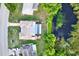 Aerial view of the home with a private pool, enclosed patio, and adjacent pond at 7305 Jasmine Blvd, Port Richey, FL 34668