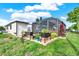 Enjoy a spacious patio and screened-in porch in this home's backyard, surrounded by garden beds and foliage at 7305 Jasmine Blvd, Port Richey, FL 34668