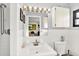 Bright bathroom featuring a well-lit vanity and a classic white tile shower at 7305 Jasmine Blvd, Port Richey, FL 34668