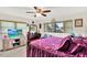 Well-lit bedroom with ceiling fan, complemented by natural light and ample storage options at 7305 Jasmine Blvd, Port Richey, FL 34668