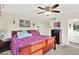 Comfortable bedroom with ample natural light, a ceiling fan, and warm color accents at 7305 Jasmine Blvd, Port Richey, FL 34668