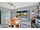 Dining room showcasing backyard pool views, hardwood floors and a modern ceiling fan at 7305 Jasmine Blvd, Port Richey, FL 34668