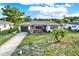 Exterior shot of a charming home with manicured front lawn and tidy landscaping at 7305 Jasmine Blvd, Port Richey, FL 34668