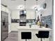 Beautiful kitchen with quartz counters, designer backsplash, stainless steel appliances and stylish pendant lighting at 7305 Jasmine Blvd, Port Richey, FL 34668