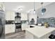 Bright kitchen with quartz counters, stainless steel appliances, stylish backsplash and lots of natural light at 7305 Jasmine Blvd, Port Richey, FL 34668