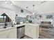 Kitchen view showing quartz counters, stainless steel appliances and sink. Opens to the living area at 7305 Jasmine Blvd, Port Richey, FL 34668