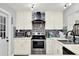 Modern kitchen featuring stainless steel appliances, quartz countertops, and a stylish backsplash at 7305 Jasmine Blvd, Port Richey, FL 34668