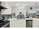 This is a view of the kitchen including stainless steel appliances, modern counters and the sink and window at 7305 Jasmine Blvd, Port Richey, FL 34668