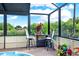 Enjoy a quiet morning or afternoon refreshment on this lanai overlooking a beautiful green landscape at 7305 Jasmine Blvd, Port Richey, FL 34668