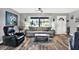 Inviting living room with wood floors, a ceiling fan, and bright natural light at 7305 Jasmine Blvd, Port Richey, FL 34668