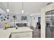Living space with modern white kitchen that opens up to a stylish seating area and living space at 7305 Jasmine Blvd, Port Richey, FL 34668