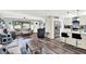 Open-concept living room with luxury vinyl plank flooring seamlessly connecting living room to modern, updated kitchen at 7305 Jasmine Blvd, Port Richey, FL 34668