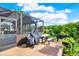 Enclosed patio with covered grill and outdoor furniture overlooking a lush backyard at 7305 Jasmine Blvd, Port Richey, FL 34668