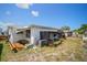 Backyard of a one story home featuring small plants, fence and lawn at 7415 Ingleside Dr, Port Richey, FL 34668