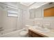 Full bathroom with shower and tub, vanity and sink, toilet, and medicine cabinet at 7415 Ingleside Dr, Port Richey, FL 34668