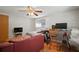 Bedroom with a bed, desk, chair, and a red leather couch at 7415 Ingleside Dr, Port Richey, FL 34668