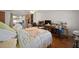 Large bedroom with wood floors, ceiling fan, large desk, and closet at 7415 Ingleside Dr, Port Richey, FL 34668