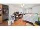Bright bedroom featuring wood floors, a ceiling fan, closet, and natural light at 7415 Ingleside Dr, Port Richey, FL 34668