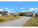 Charming home with a long driveway and an attached garage at 7415 Ingleside Dr, Port Richey, FL 34668