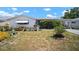 A charming single story home with a white exterior, an awning, and a small well kept front yard at 7415 Ingleside Dr, Port Richey, FL 34668