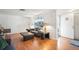 A cozy living room featuring wood floors, natural light, and a gray sofa set at 7415 Ingleside Dr, Port Richey, FL 34668