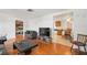 The living room flows into the dining and kitchen areas, with wood floors at 7415 Ingleside Dr, Port Richey, FL 34668