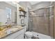 Modern bathroom featuring granite counters, a glass-enclosed shower, stylish fixtures, and contemporary design elements at 7570 Sweeter Tide Trl, Wesley Chapel, FL 33545