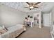Bedroom with cloud-like ceiling, carpet, and a view of the closet at 7570 Sweeter Tide Trl, Wesley Chapel, FL 33545