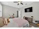 Comfortable bedroom with a cozy bed, a sleek TV, and an inviting atmosphere perfect for relaxation and rest at 7570 Sweeter Tide Trl, Wesley Chapel, FL 33545