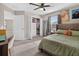 Well-lit bedroom with carpet and a closet with built-in storage at 7570 Sweeter Tide Trl, Wesley Chapel, FL 33545