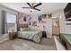 Well-lit bedroom features neutral walls, carpet, a ceiling fan, and a connected bath at 7570 Sweeter Tide Trl, Wesley Chapel, FL 33545