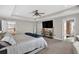Primary bedroom featuring tray ceiling, neutral carpet, sitting area, and neutral walls at 7570 Sweeter Tide Trl, Wesley Chapel, FL 33545