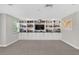 Bright bonus room with custom built-ins, offering a perfect space for a home office, library, or entertainment area at 7570 Sweeter Tide Trl, Wesley Chapel, FL 33545