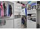 Spacious walk-in closet with built-in shelving, drawers, and ample hanging space at 7570 Sweeter Tide Trl, Wesley Chapel, FL 33545