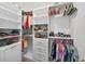 Walk-in closet features custom shelving, hanging rods, and drawers for optimal storage at 7570 Sweeter Tide Trl, Wesley Chapel, FL 33545