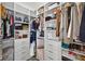 Well-organized closet features custom shelving, drawers, and multiple hanging rods at 7570 Sweeter Tide Trl, Wesley Chapel, FL 33545