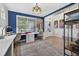 Well-lit craft room featuring built-in desks, shelving, and easy access to the foyer at 7570 Sweeter Tide Trl, Wesley Chapel, FL 33545