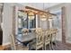 Stylish dining room with decorative chandelier over a wooden table with seating for six and decorative rug at 7570 Sweeter Tide Trl, Wesley Chapel, FL 33545