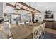Open floor plan with dining area featuring chandelier lighting over a wooden table near the kitchen and living room at 7570 Sweeter Tide Trl, Wesley Chapel, FL 33545