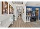 Spacious foyer with light wood floors, elegant artwork, and a glimpse into the adjacent dining space at 7570 Sweeter Tide Trl, Wesley Chapel, FL 33545