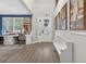 Bright foyer with natural light, a white bench, and views into the adjacent craft room at 7570 Sweeter Tide Trl, Wesley Chapel, FL 33545